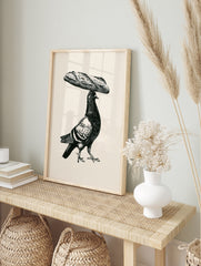 Black and white illustrative art print of a pigeon balancing a baguette on its head on a, in an alternate framed mockup
