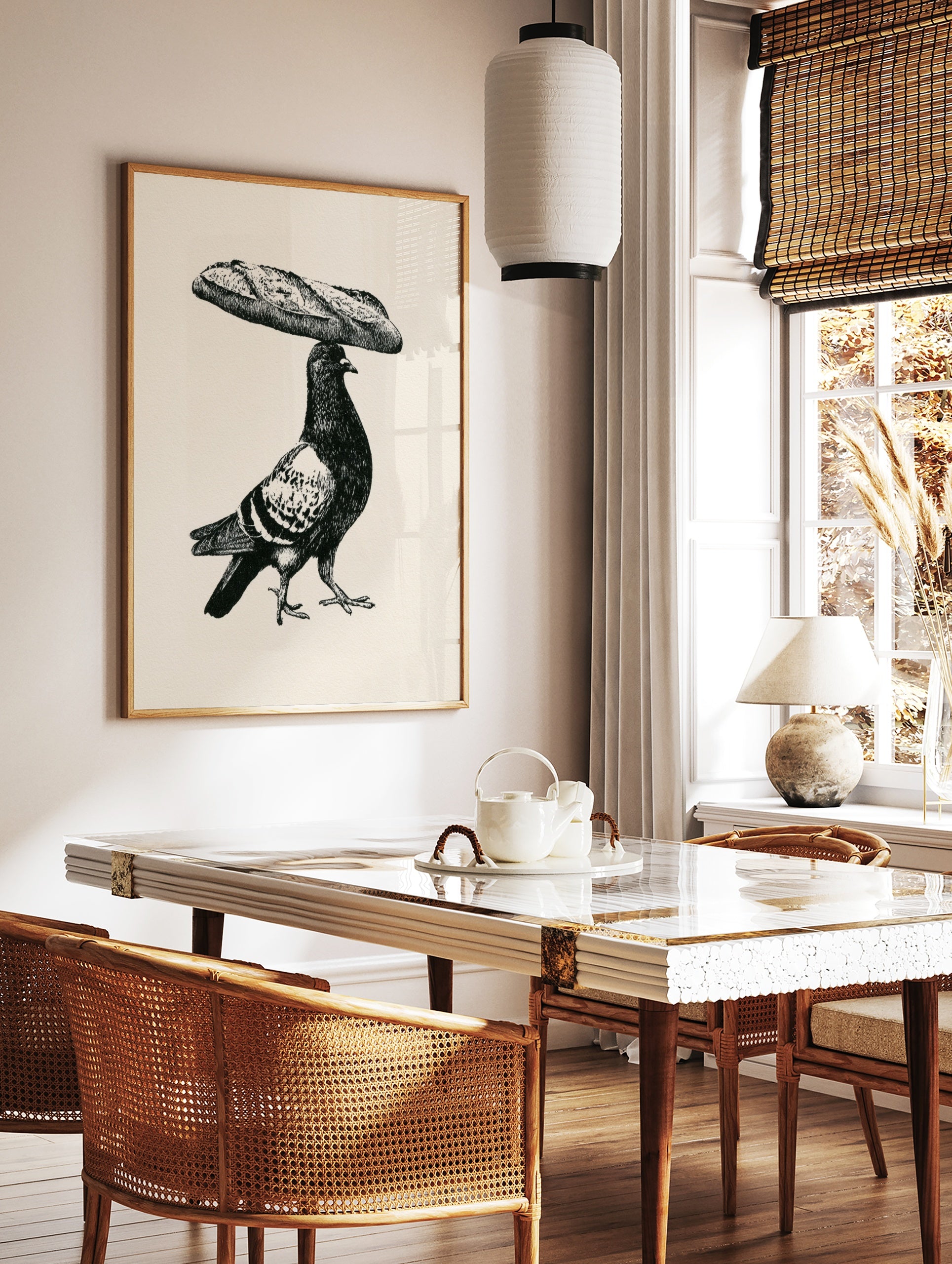 Black and white illustrative art print of a pigeon balancing a baguette on its head on a cream, in a styled room mockup