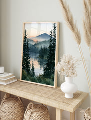 Watercolor-style misty pine forest landscape with sunrise reflecting on a calm lake, vertical, in an alternate framed mockup