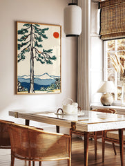 Illustrative pine tree with dark green foliage, red sun, blue mountains, and water in a serene, in a styled room mockup