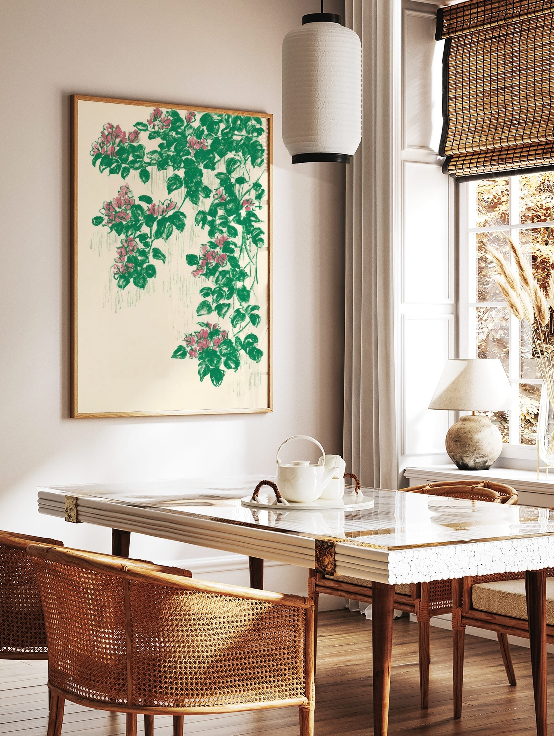 Illustrative botanical print with cascading pink flowers and green leaves on a cream background, in a styled room mockup