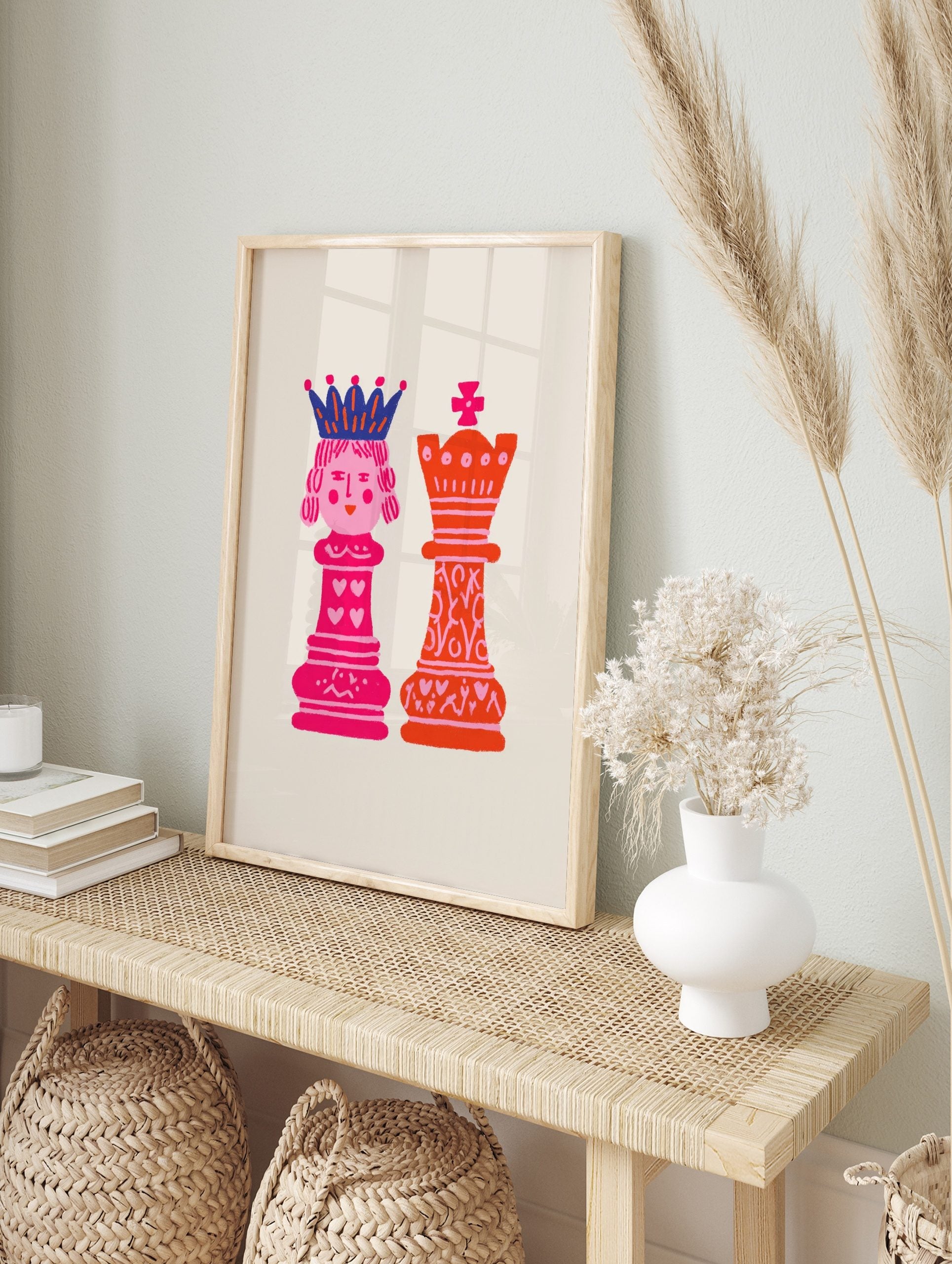 Illustrative art print of pink chess queen and orange king with hearts on a light background, in an alternate framed mockup