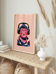 Illustrative print of a pink Buddha figure wearing black headphones against a light pink, in an alternate framed mockup