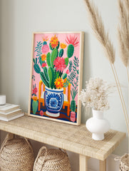 Vibrant pink cactus poster with green cacti and colorful red, orange, and yellow flowers in a blue and white decorative pot on a pink background. - Image 4