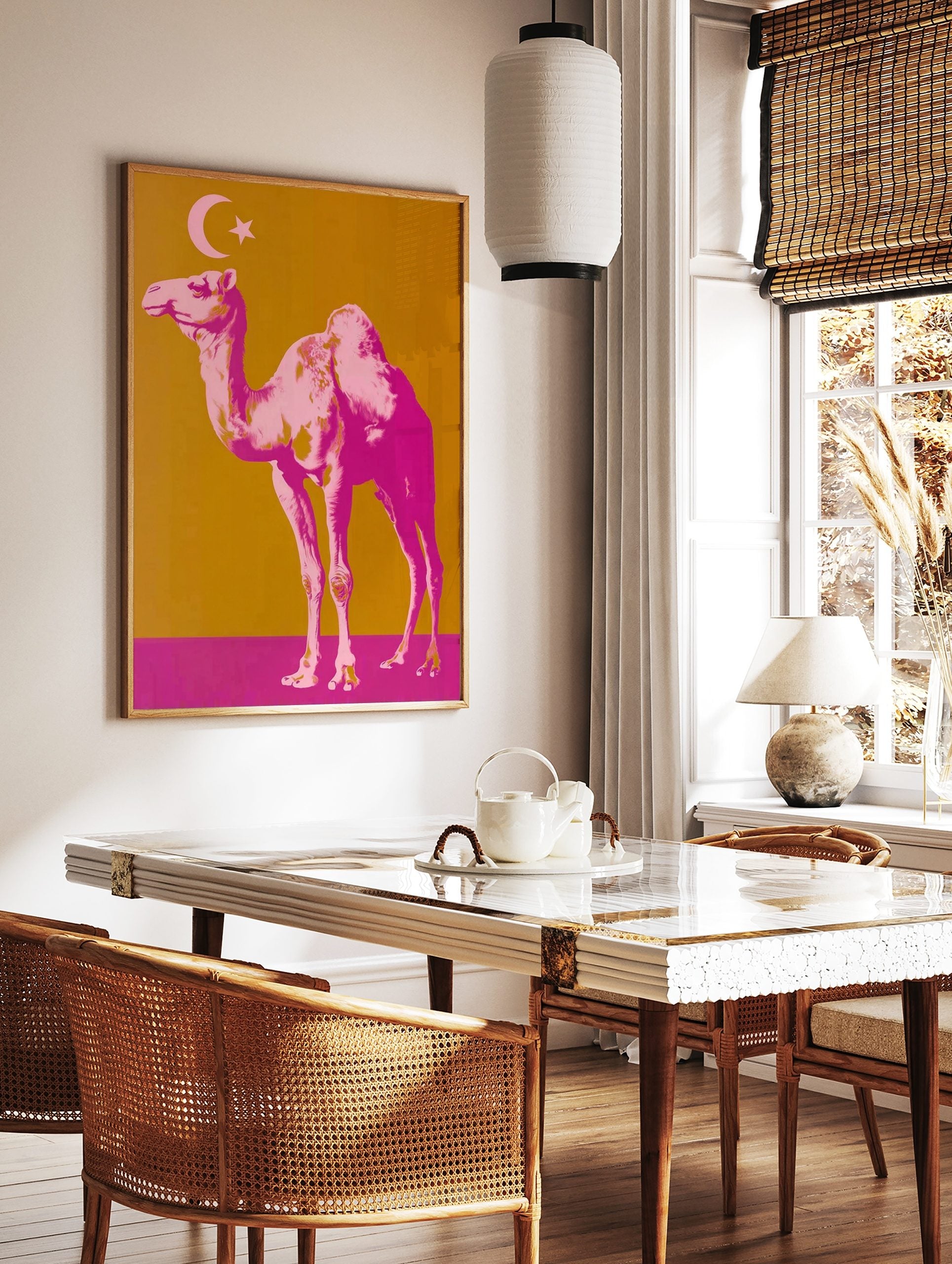 Pop art style print of a pink camel with a crescent moon and star on a golden-orange and magenta, in a styled room mockup