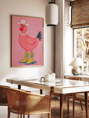 Pink chicken wearing a white cowboy hat, pearl necklace, and yellow cowboy boots on a pink, in a styled room mockup