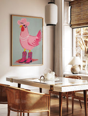 Illustrative pink chicken wearing a cowboy hat, pearl necklace, and pink cowboy boots on a light, in a styled room mockup