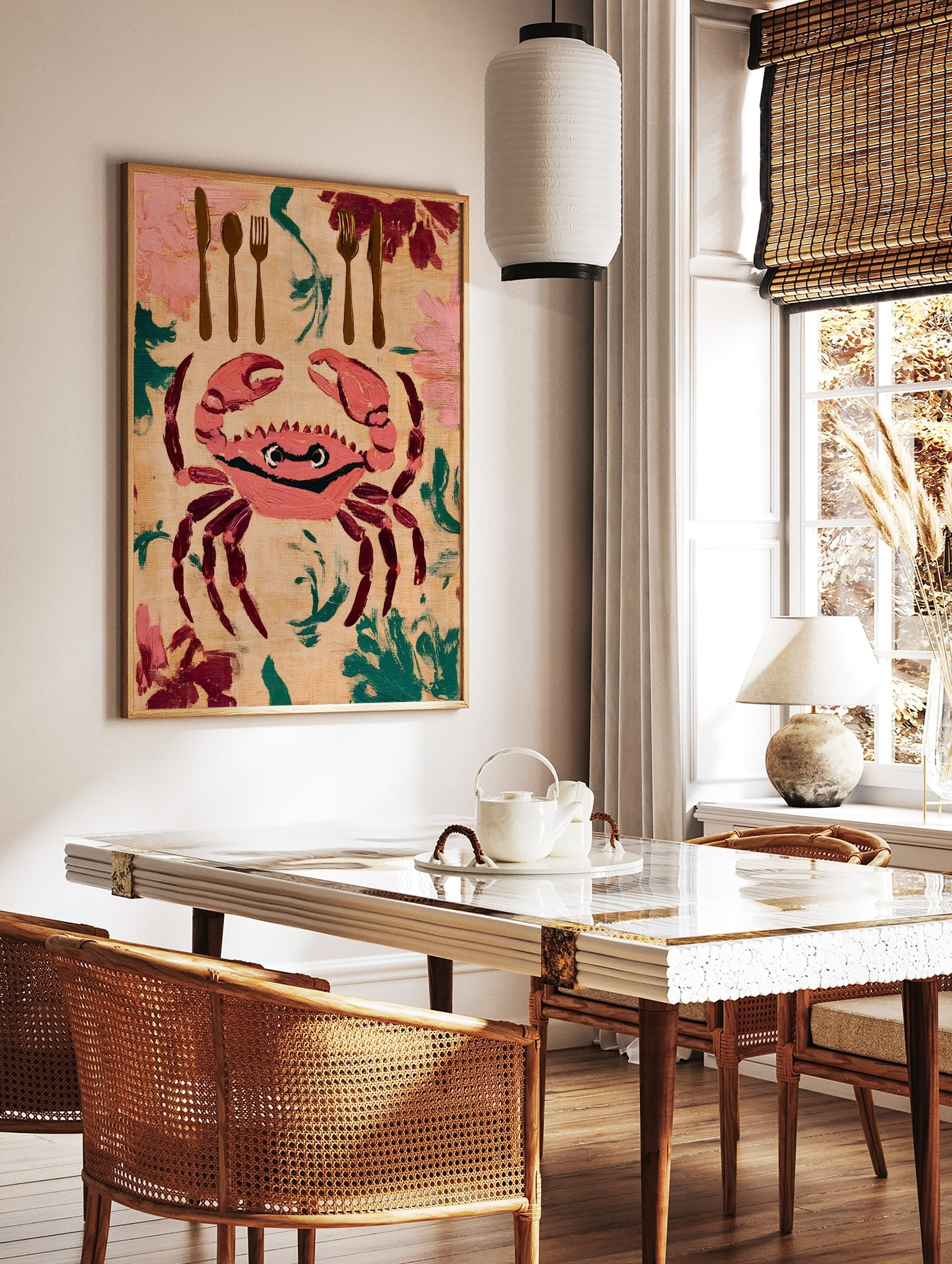 Illustrative wall art print of a pink crab with cutlery and foliage on a beige background, in a styled room mockup