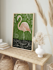 Illustrative pink flamingo standing in water with green foliage background art print, in an alternate framed mockup