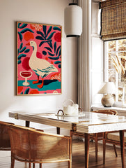 Illustrative painting of a white goose with orange beak, red wine glass, and teal leaves on a pink, in a styled room mockup