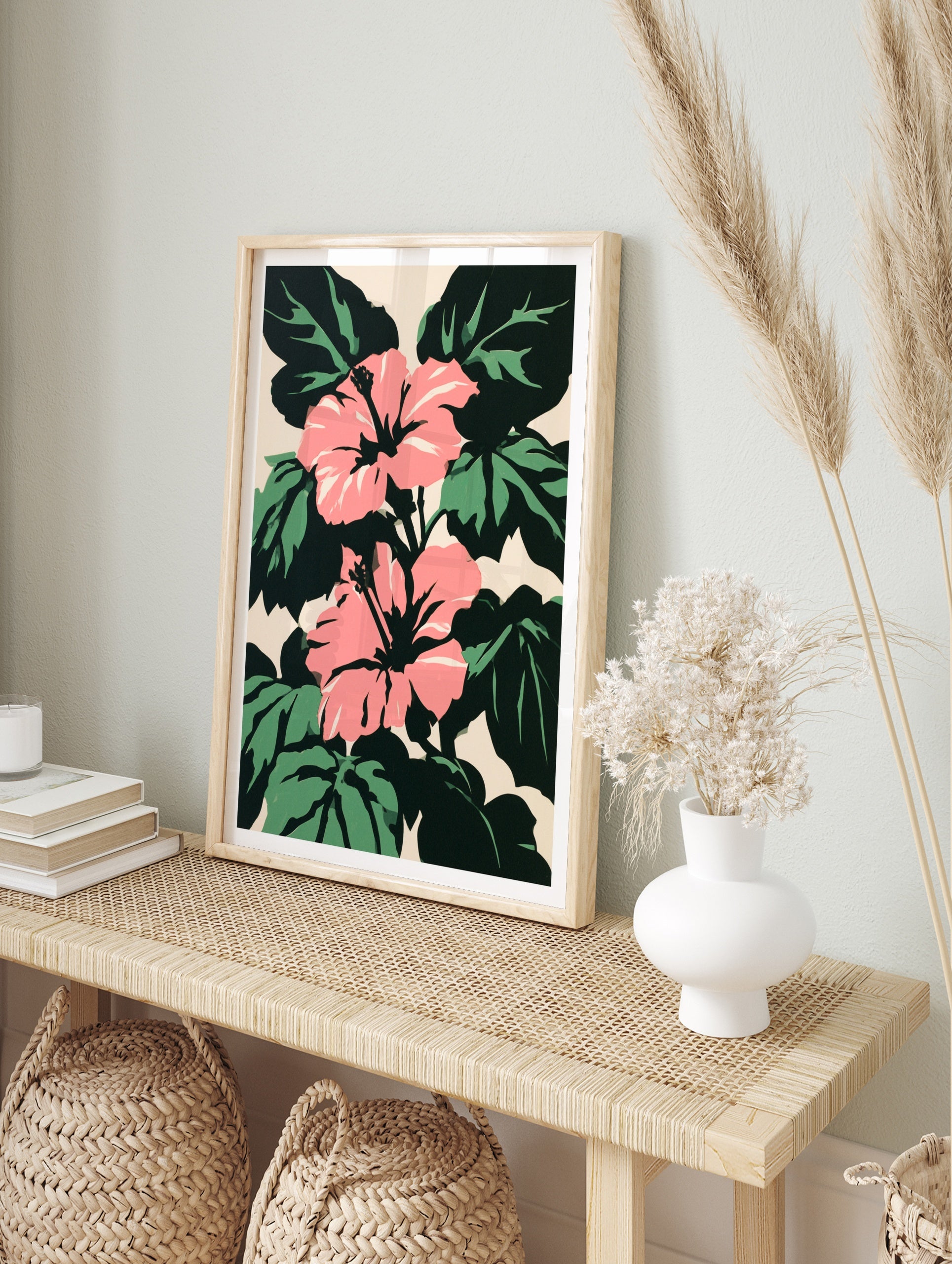 Pink hibiscus flowers with dark green leaves on a light beige background in a bold graphic, in an alternate framed mockup