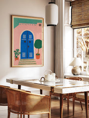 Pink house wall art illustration with a blue arched door, green roof, potted plants, and patterned steps. - Image 2