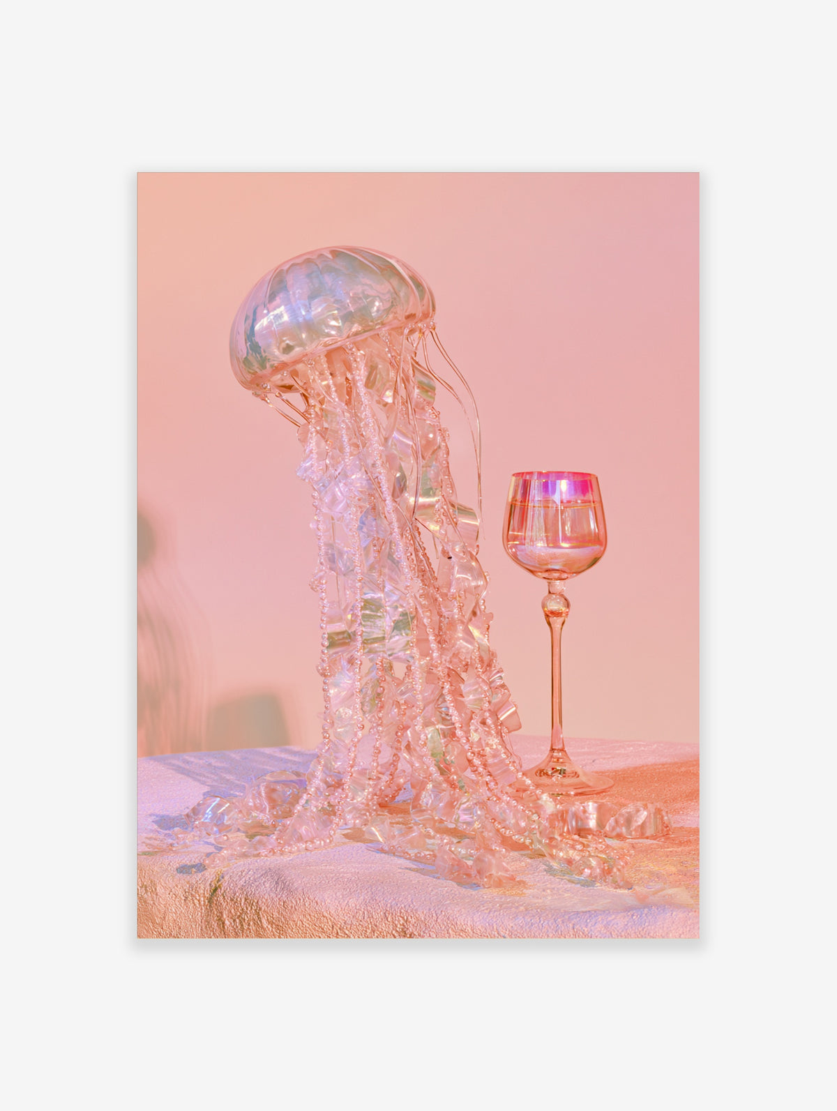 Pink jellyfish art print with iridescent beaded tentacles beside a pink wine glass on a pink background