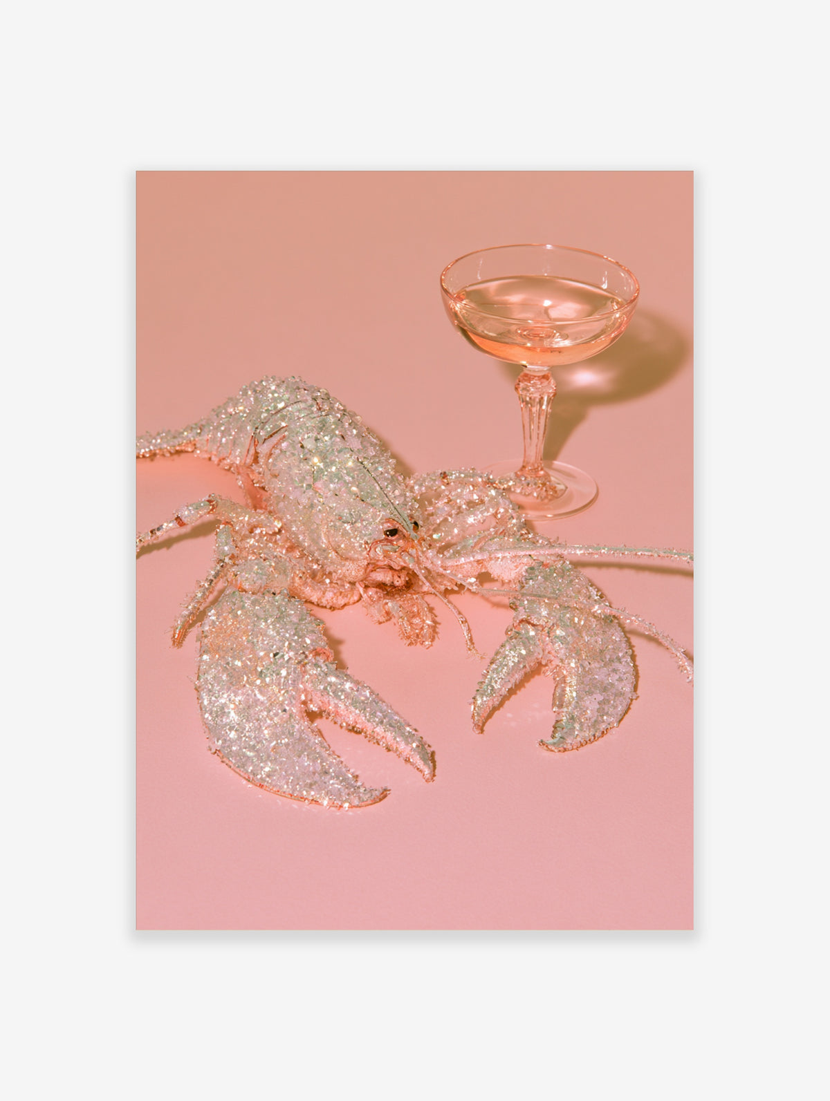 Pink lobster with crystal texture next to a coupe glass of rosé on a blush background, wall art print