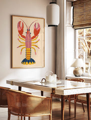 Illustrative pink lobster print with dotted red claws, yellow legs, and navy tail on a beige, in a styled room mockup