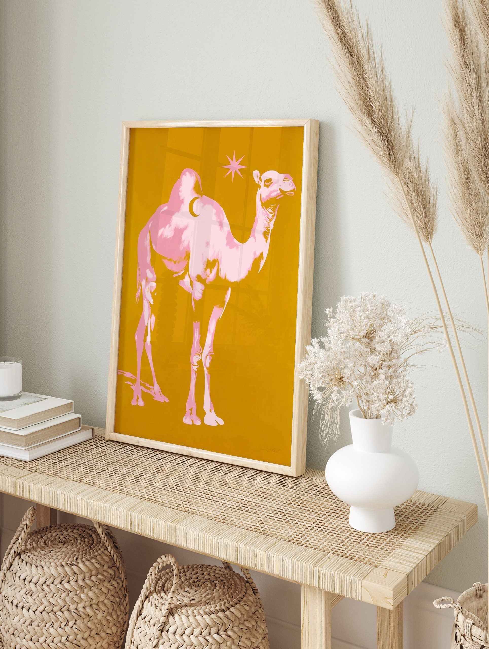 Pink pop art camel with crescent moon on hump and star on golden yellow background, in an alternate framed mockup