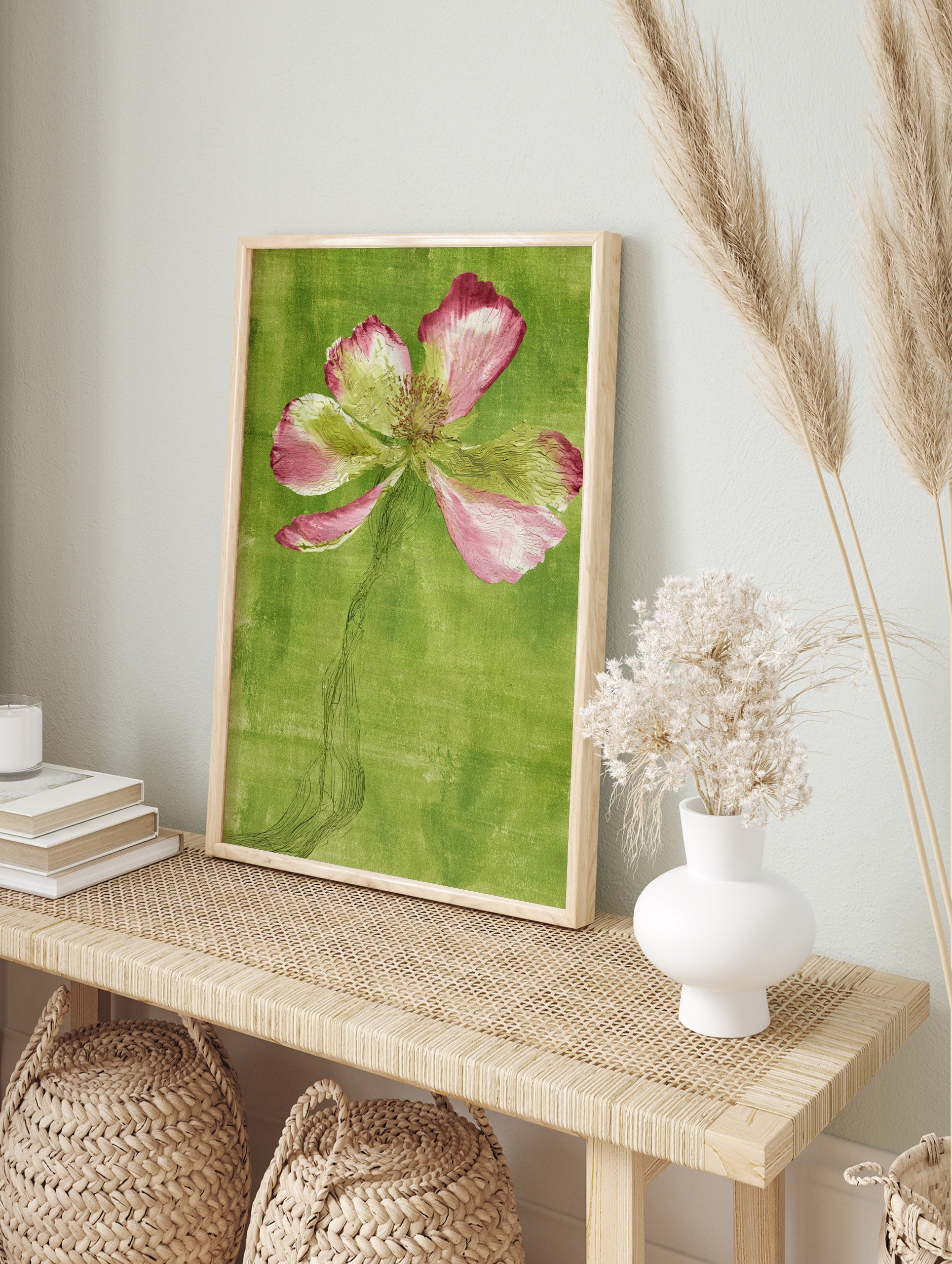 Stylized pink poppy flower illustration with an etched stem against a textured green, in an alternate framed mockup