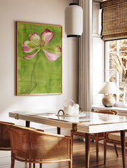 Stylized pink poppy flower illustration with an etched stem against a textured green background, in a styled room mockup