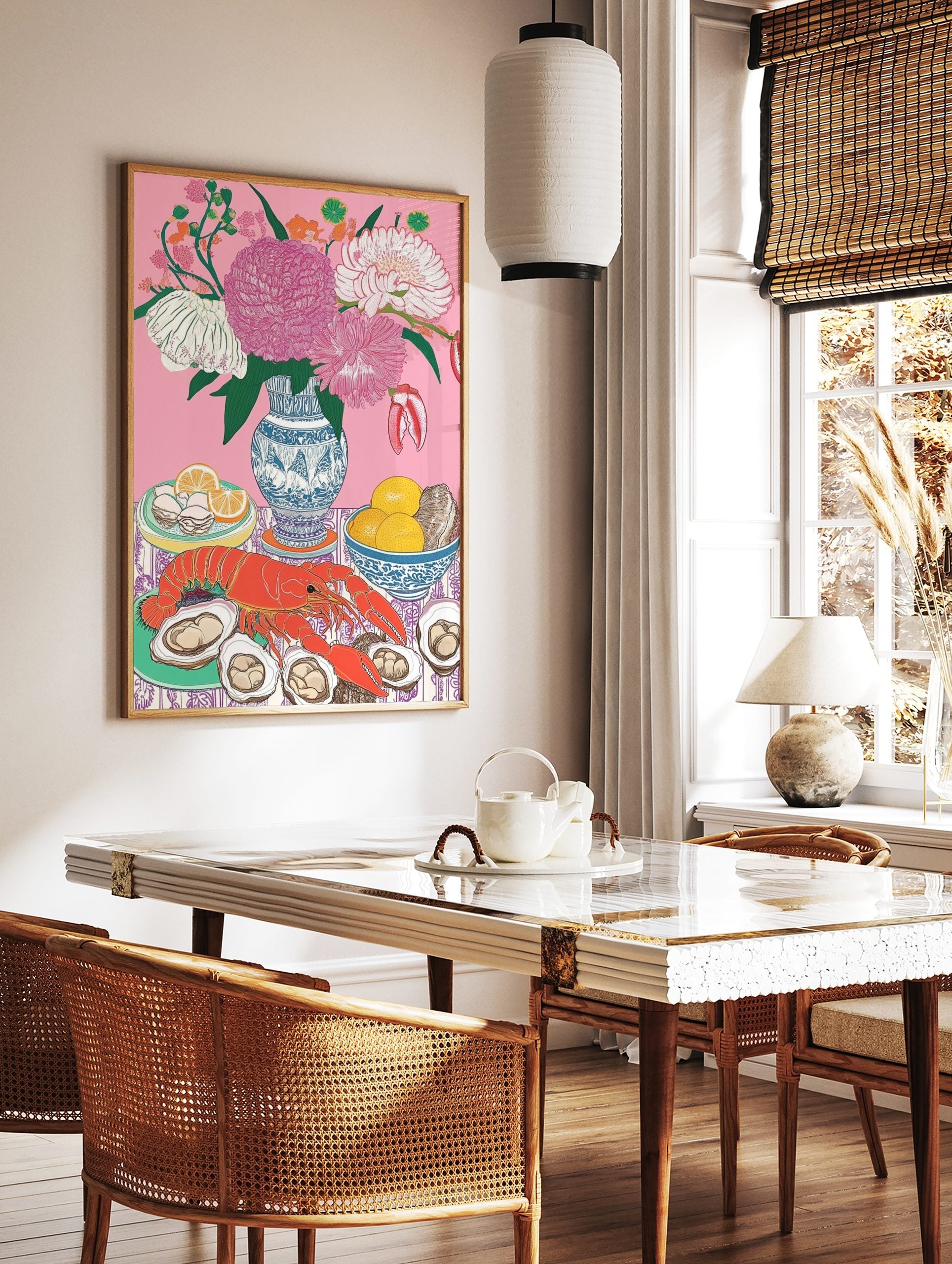 Still life illustration of red lobster, oysters, lemons, and pink flowers in blue vase on pink, in a styled room mockup