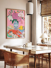 Still life illustration of red lobster, oysters, lemons, and pink flowers in blue vase on pink, in a styled room mockup