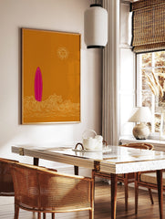 Pink surfboard standing in white ocean waves with a smiling sun on an ochre background in an, in a styled room mockup