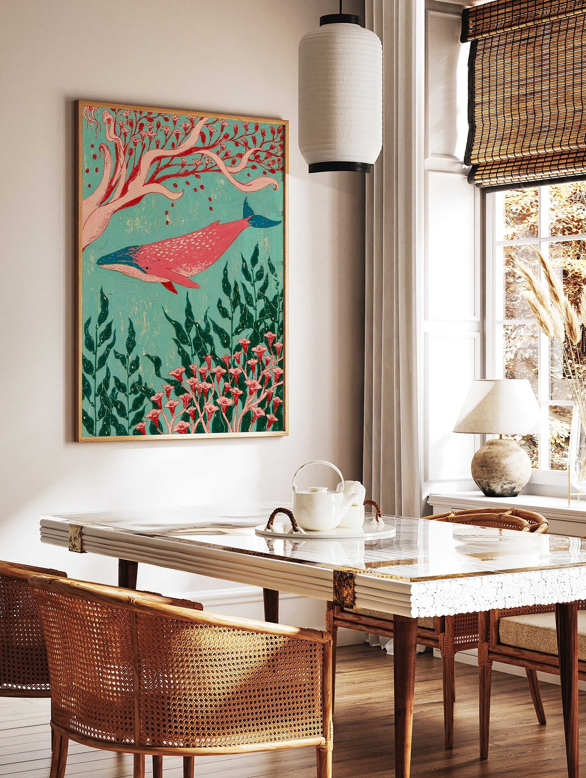 Pink whale swimming among red botanical flowers and green seaweed on a turquoise background, in a styled room mockup