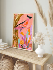 Illustrative pink whale swimming through golden kelp and colourful flowers on a coral, in an alternate framed mockup