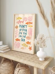 Illustrative Plenty of Fish in the Sea print with hand-drawn fish, coral, seashells, and, in an alternate framed mockup