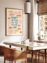 Illustrative Plenty of Fish in the Sea print with hand-drawn fish, coral, seashells, and starfish, in a styled room mockup