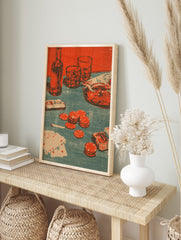 Poker night still life print with bottle, glasses, revolver, playing cards, and red poker, in an alternate framed mockup