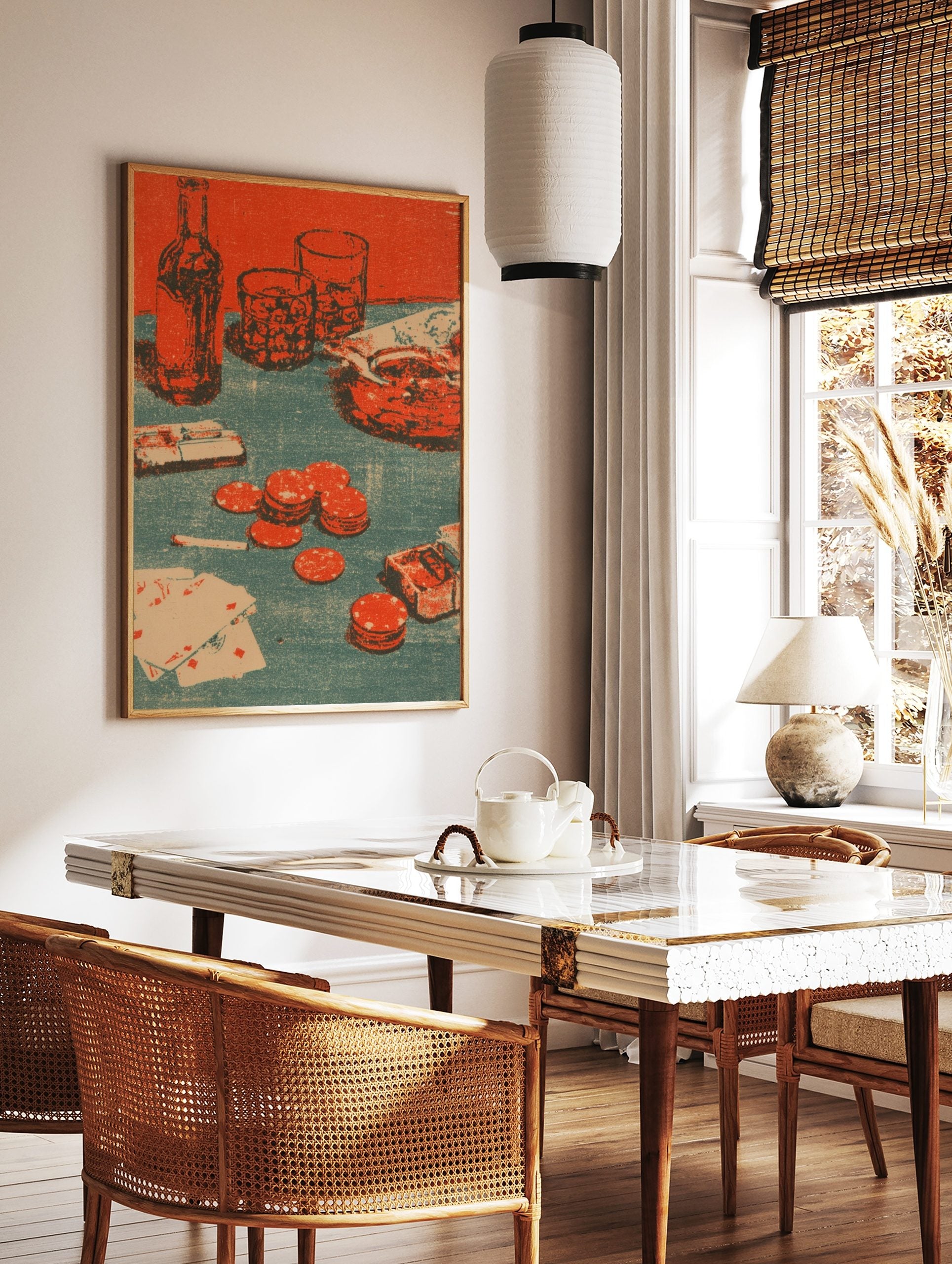 Poker night still life print with bottle, glasses, revolver, playing cards, and red poker chips on, in a styled room mockup