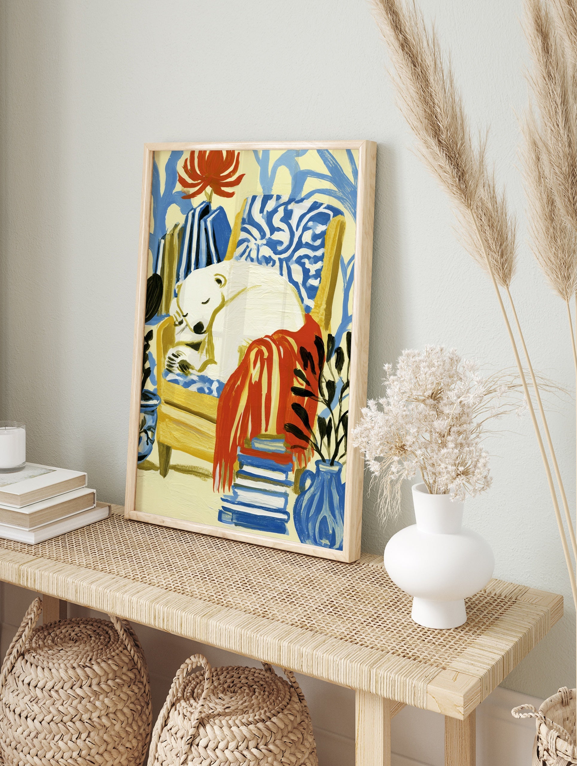 Sleeping polar bear in a yellow armchair with a red blanket, plants, and books, illustrative, in an alternate framed mockup