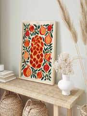Illustrative wall art print of a central braided challah bread surrounded by red pomegranates, in an alternate framed mockup