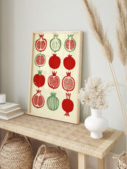 Illustrative pomegranate botanical grid print with red and green fruit on cream background, in an alternate framed mockup