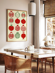 Illustrative pomegranate botanical grid print with red and green fruit on cream background, in a styled room mockup