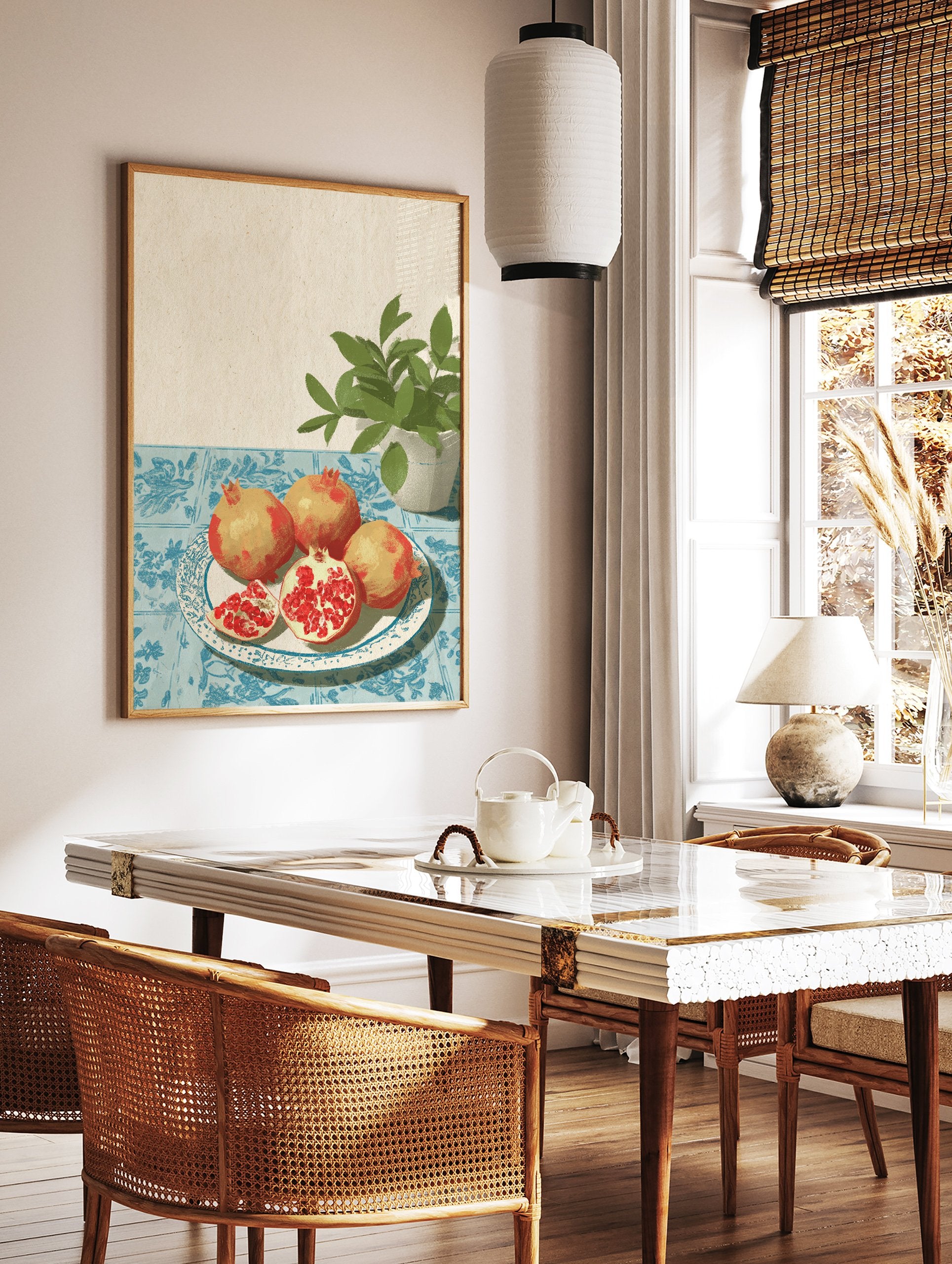 Illustrative pomegranate wall art with whole and sliced pomegranates on a plate, blue tablecloth, and green plant. - Image 2