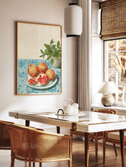 Illustrative pomegranate wall art with whole and sliced pomegranates on a plate, blue tablecloth, and green plant. - Image 2
