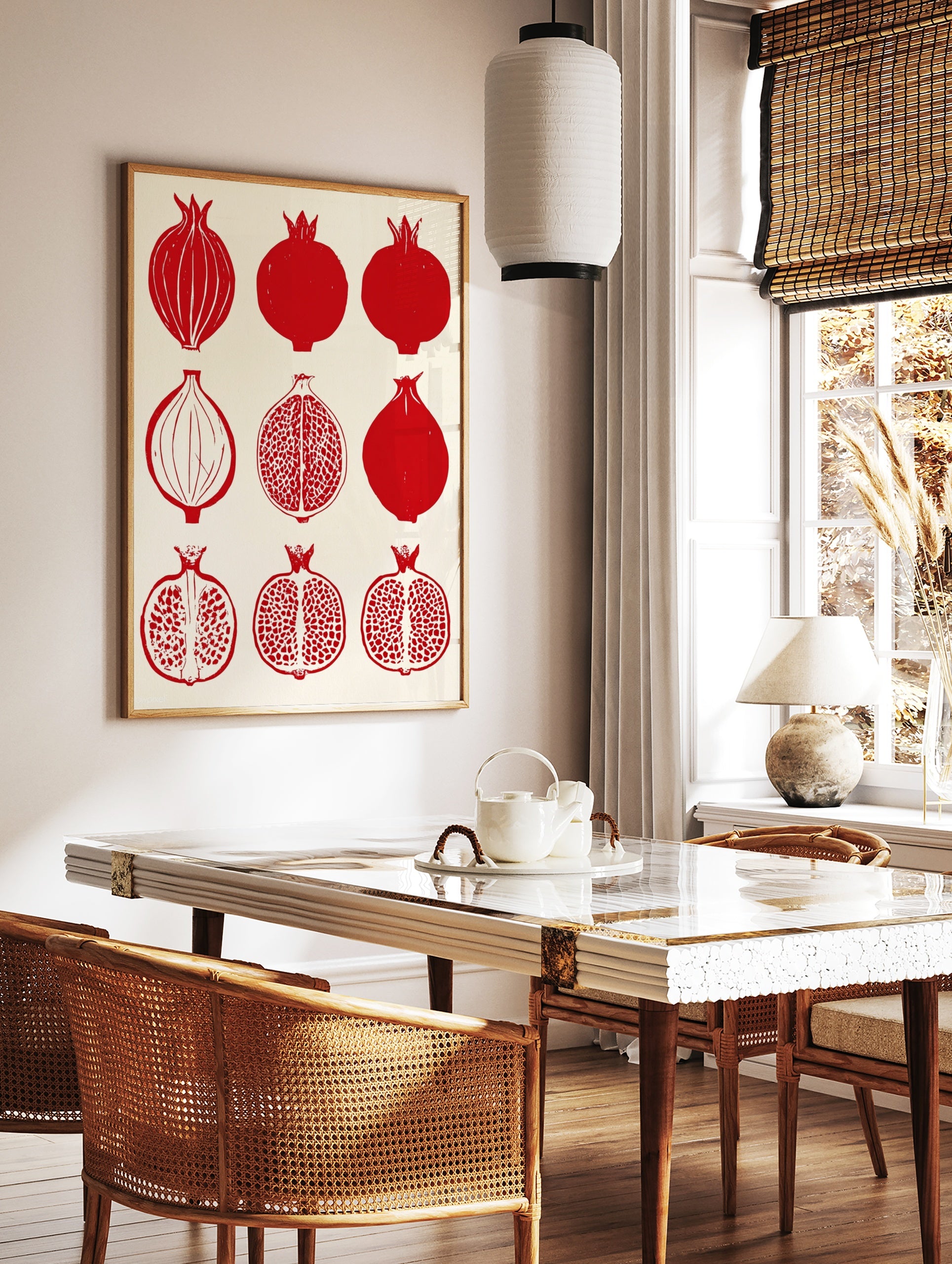 Grid of nine illustrative red pomegranate fruits, both whole and halved, on a cream background, in a styled room mockup