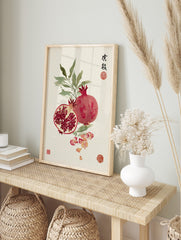Pomegranate watercolour illustration with whole and cut fruit, green leaves, scattered, in an alternate framed mockup
