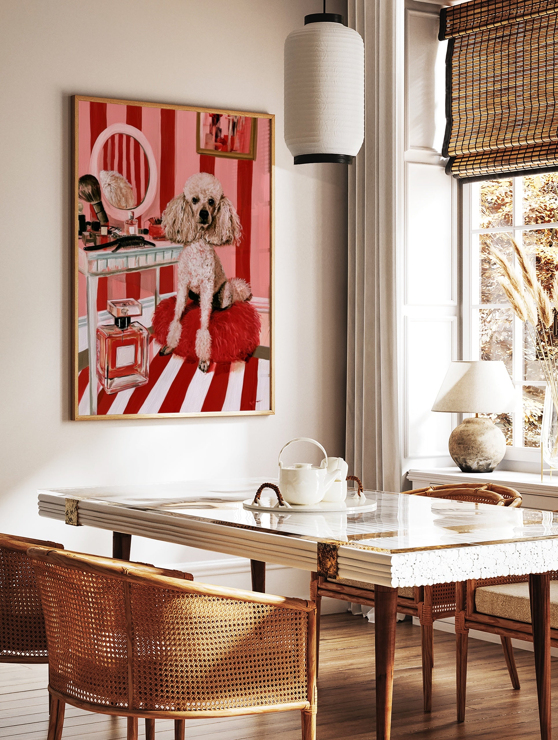 Illustrative print of a fluffy poodle on a red cushion before a vanity with a mirror and perfume, in a styled room mockup