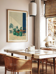 Illustrative print of potted plants on a tiled patio with a blue wall stripe and diagonal sunlight, in a styled room mockup