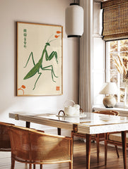 Stylised green praying mantis illustration in a woodblock print style with orange accents on a, in a styled room mockup