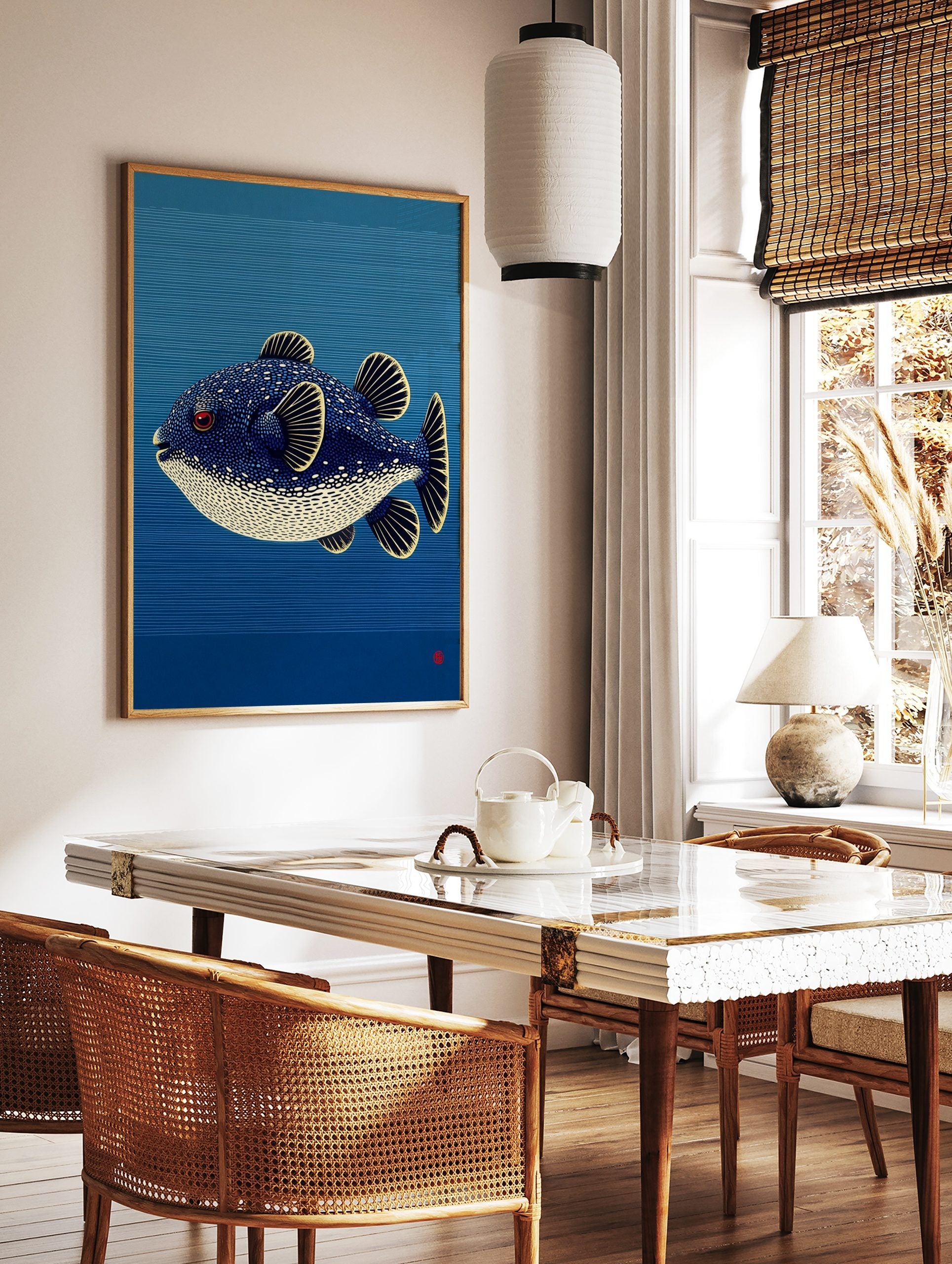 Illustrative puffer fish with blue, white spots, red eye, yellow fins against blue striped, in a styled room mockup