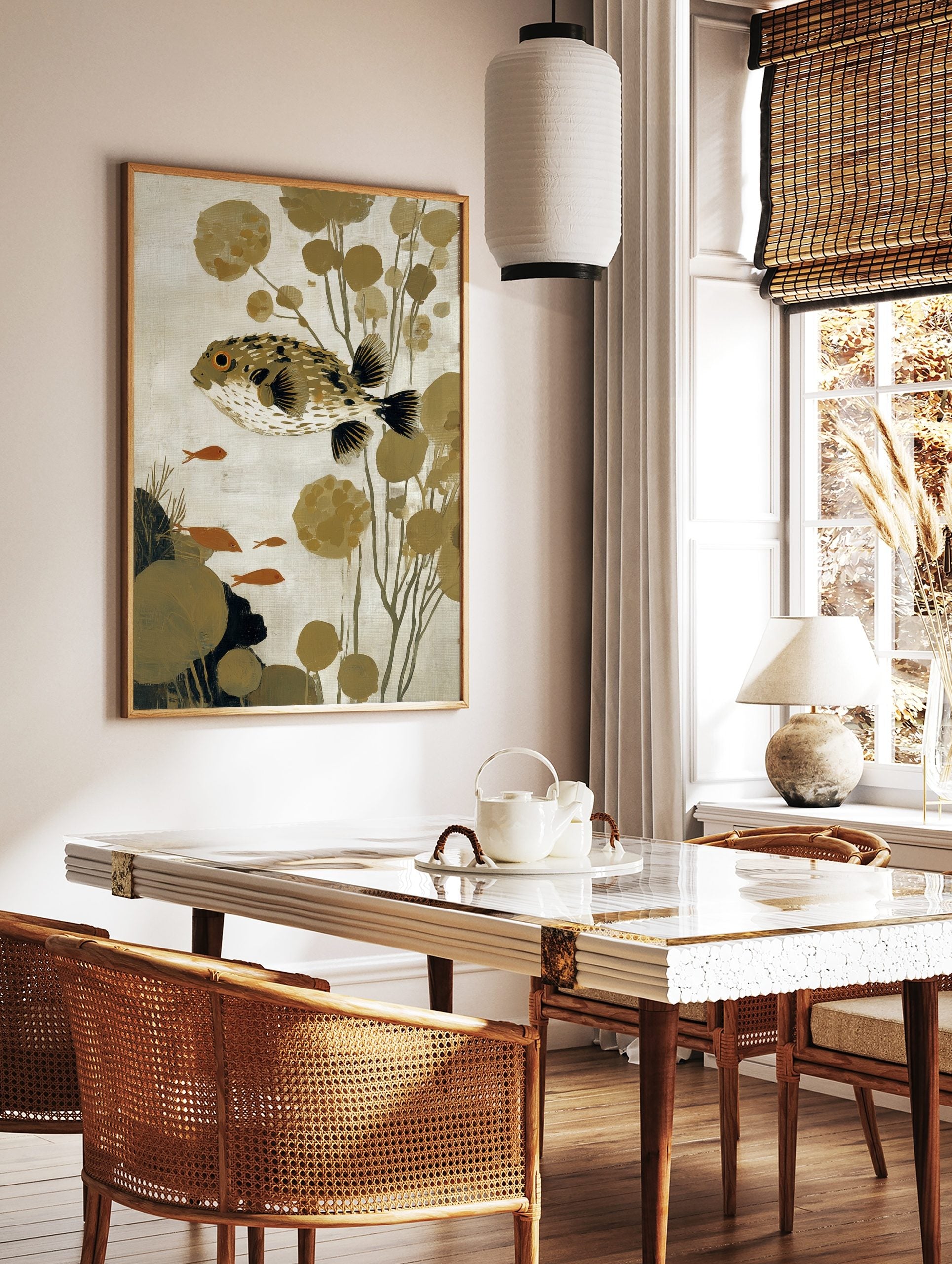 Illustrative puffer fish wall art with spiky body, orange eye, olive plants, and small orange fish, in a styled room mockup