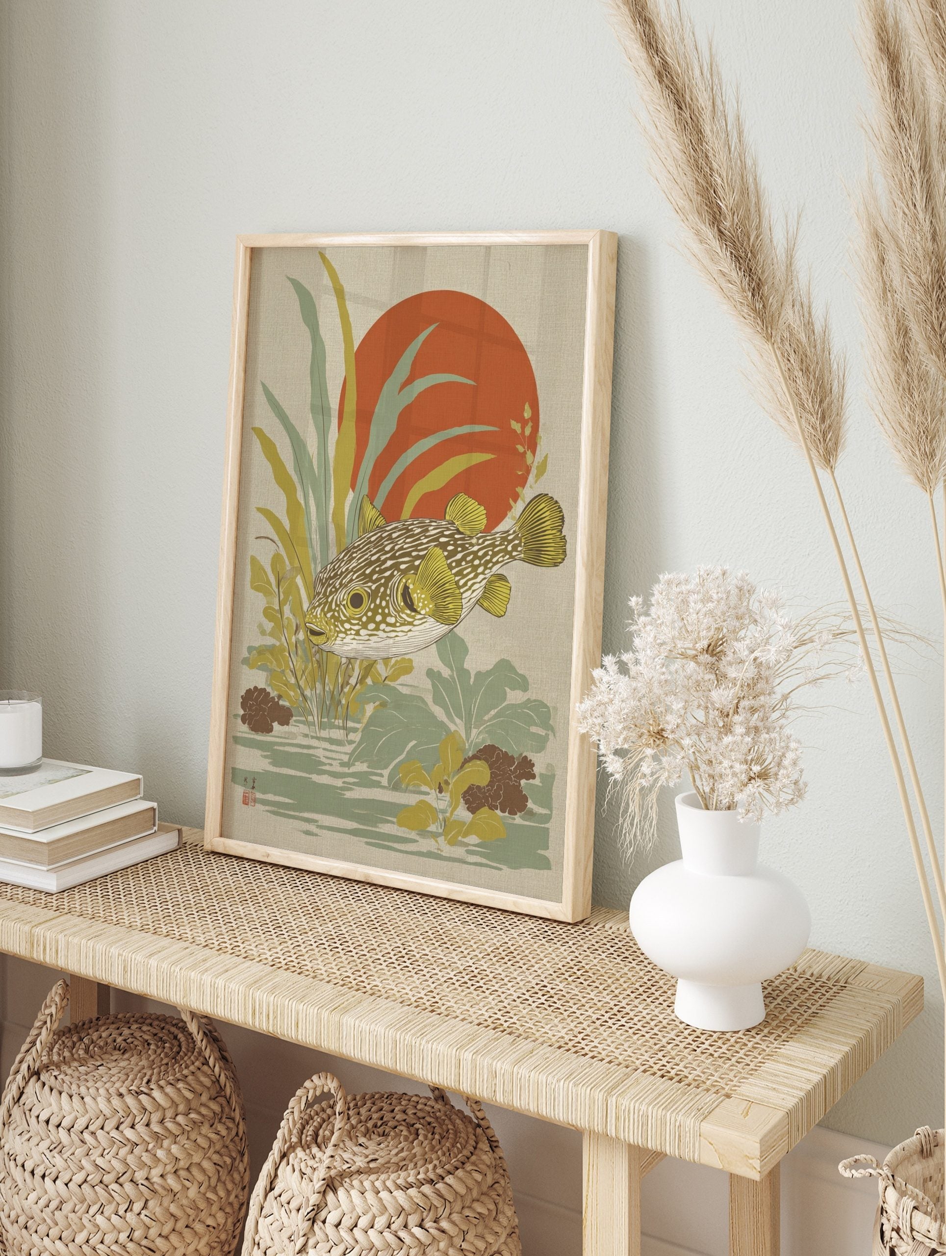 Japanese style puffer fish wall art with yellow fins, green-brown body, red sun, and aquatic, in an alternate framed mockup