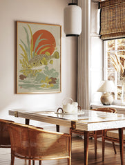 Japanese style puffer fish wall art with yellow fins, green-brown body, red sun, and aquatic plants, in a styled room mockup