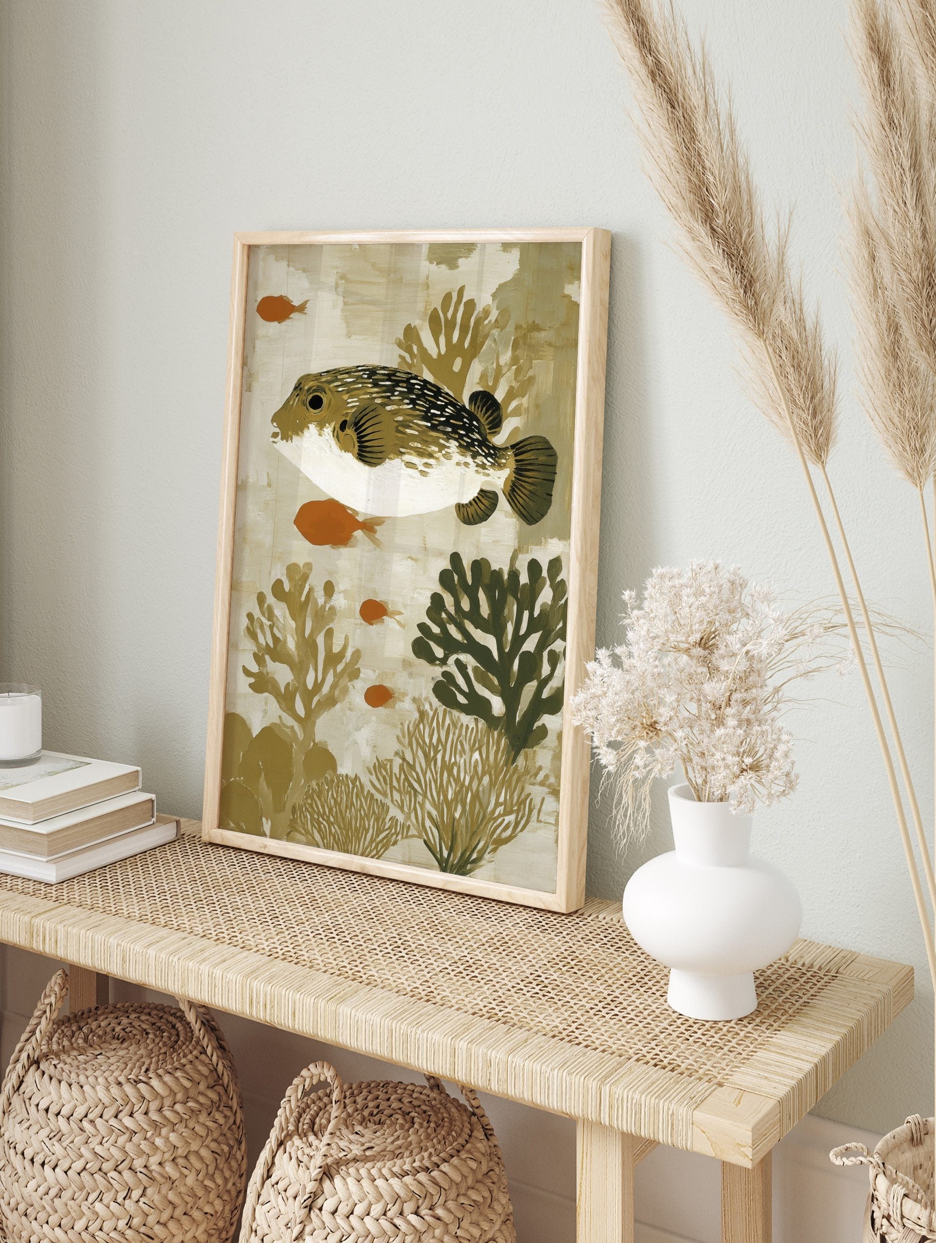 Illustrative art print of a spotted pufferfish with orange fish and coral in earthy tones, in an alternate framed mockup