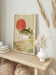 Pufferfish swimming in water with a large red sun in the background, Japanese woodblock style, in an alternate framed mockup