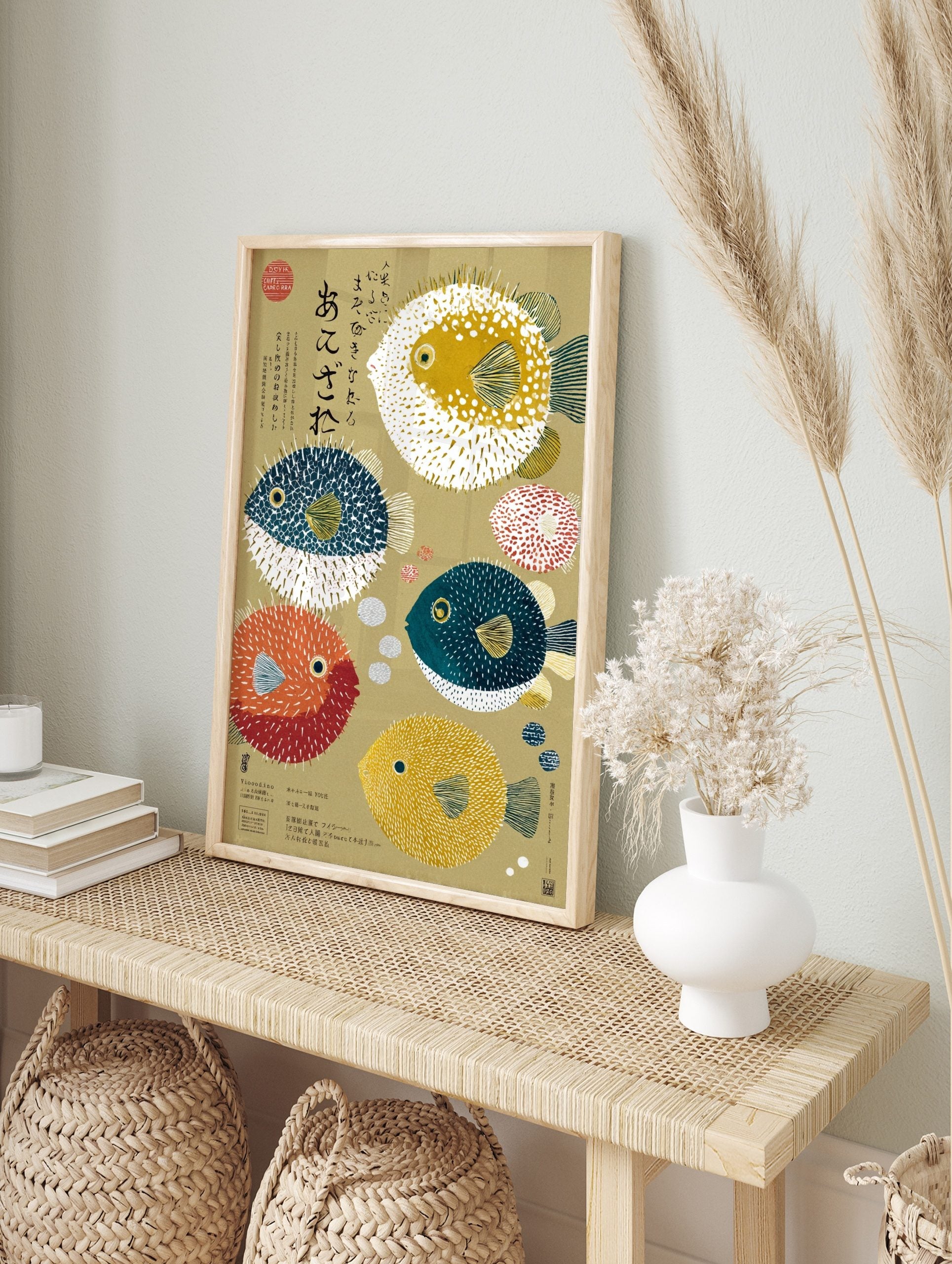 Illustrative art print of various colourful pufferfish and Japanese calligraphy on a beige, in an alternate framed mockup