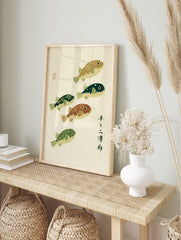 Japanese-style woodblock print with five pufferfish in varied green and brown tones, in an alternate framed mockup